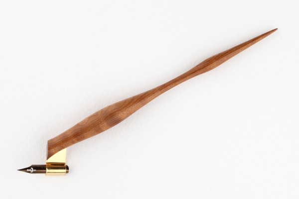 Oblique pen holder made of steamed curly american cherry and finished with natural wax.